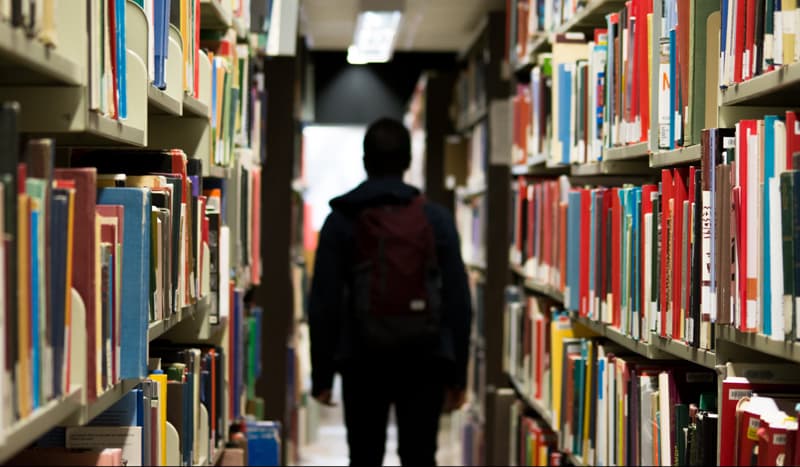 student in library